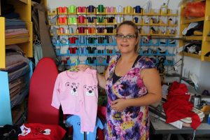 Dragica shows children’s clothing made in her workshop